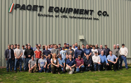 employee workforce pose in front of building