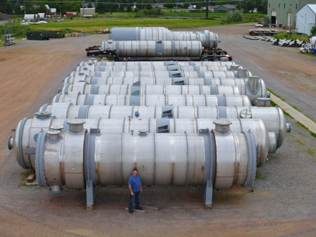 man in front of many heat exchangers