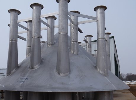 large metal venting cap with many stacks